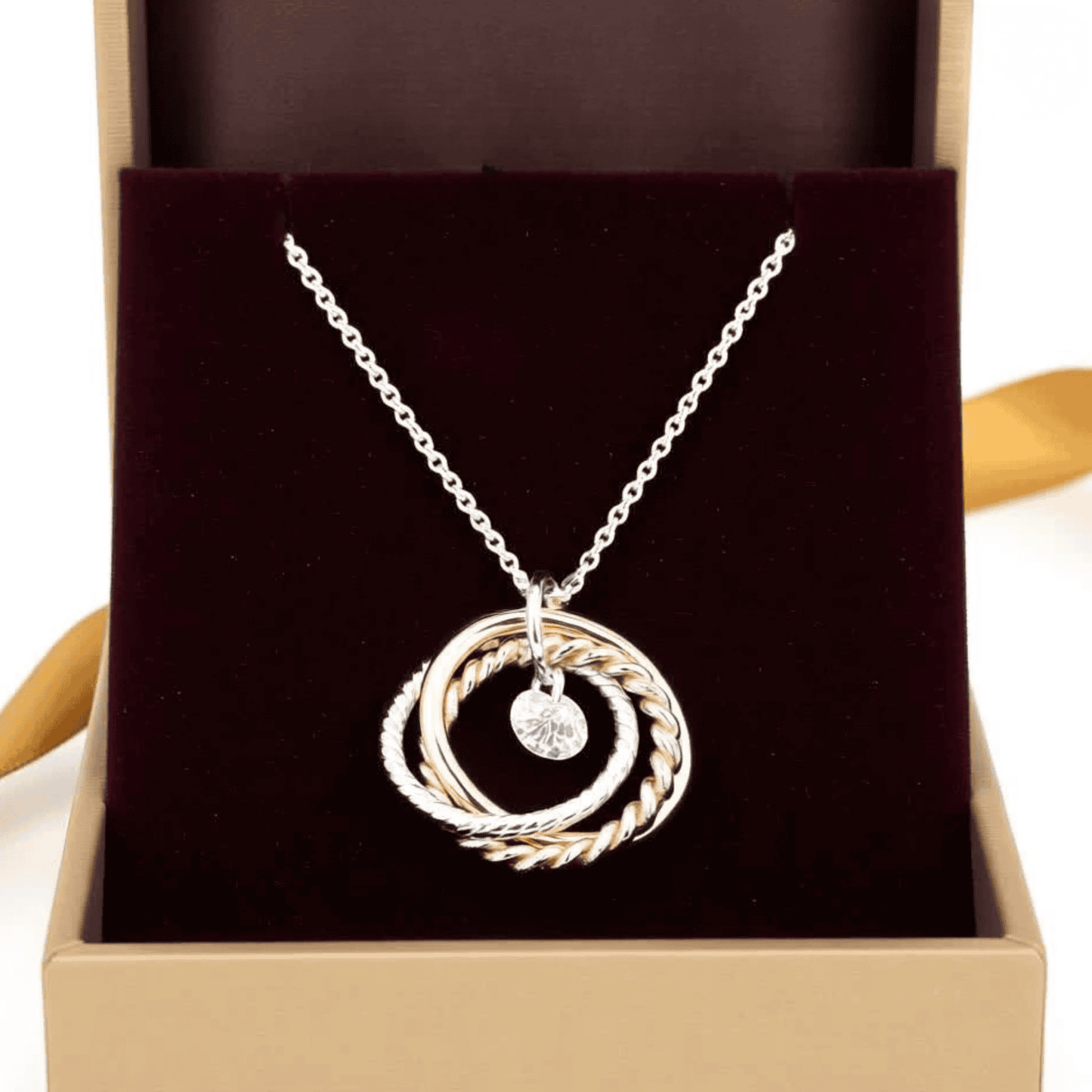 Necklace Intertwined 3 tone rings with a CZ drop