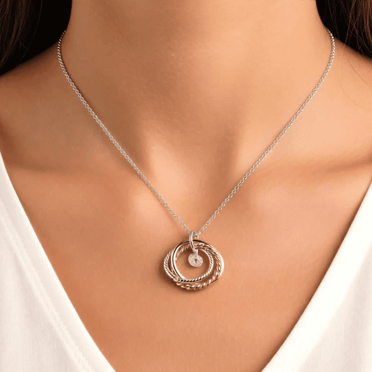 Necklace Intertwined 3 tone rings with a CZ drop