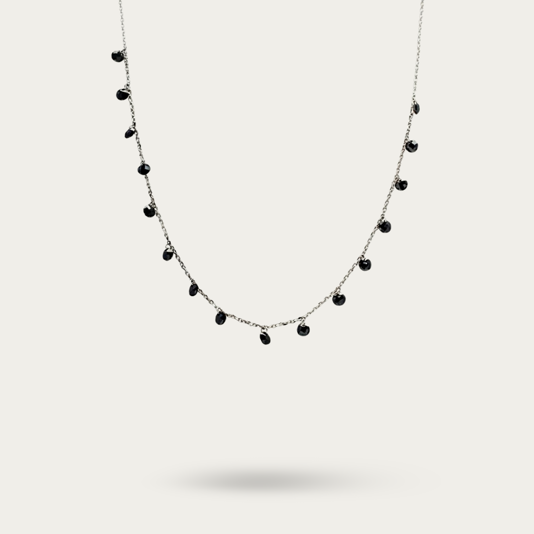 Necklace with drops of black crystals on dainty silver chain