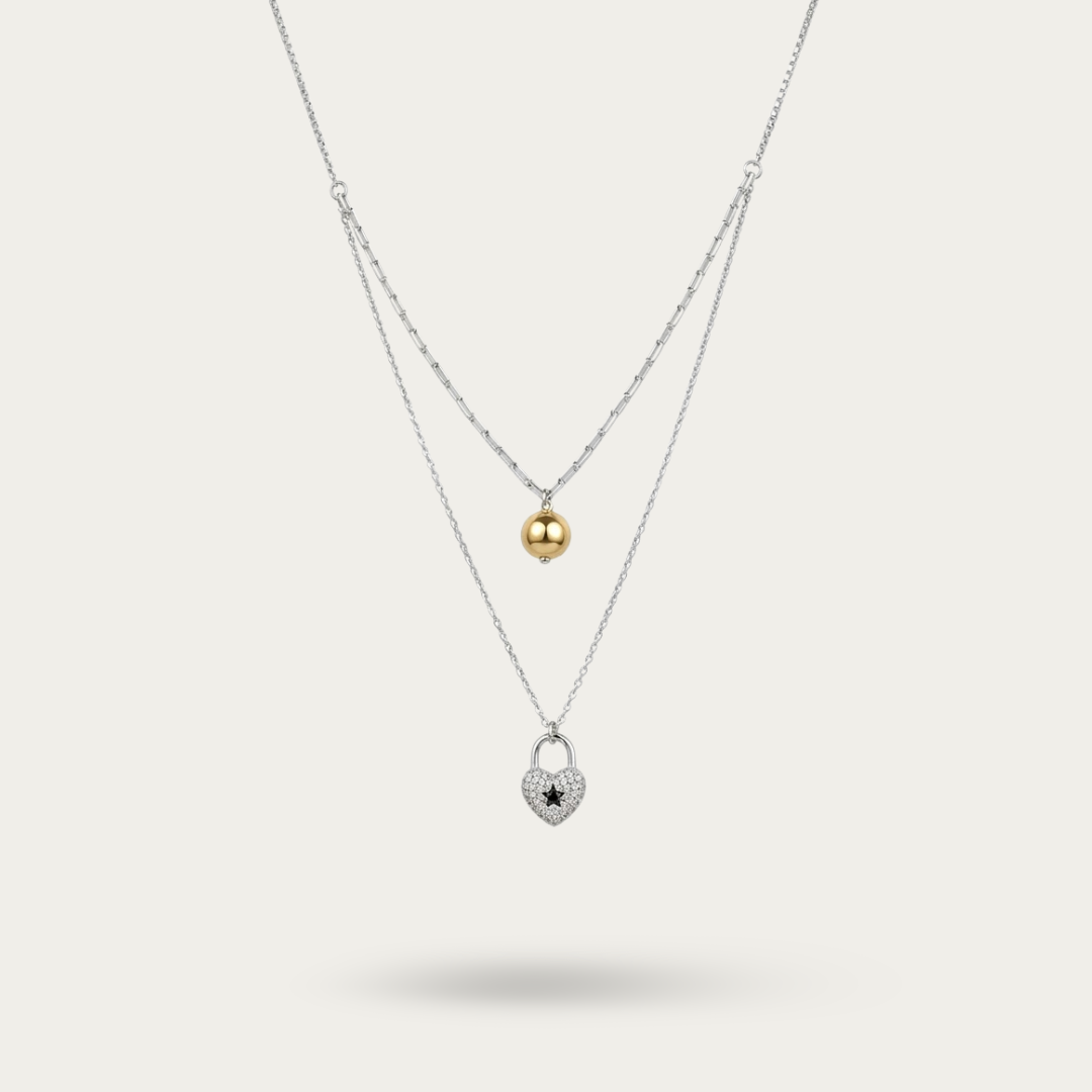 Necklace with heart shaped pendant and pearl drop