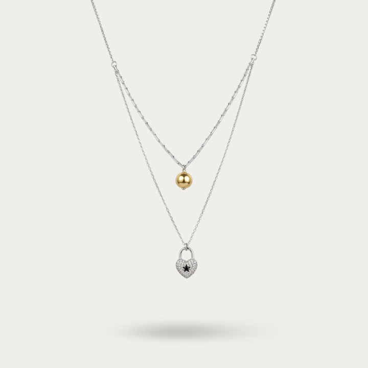 Necklace with heart shaped pendant and pearl drop