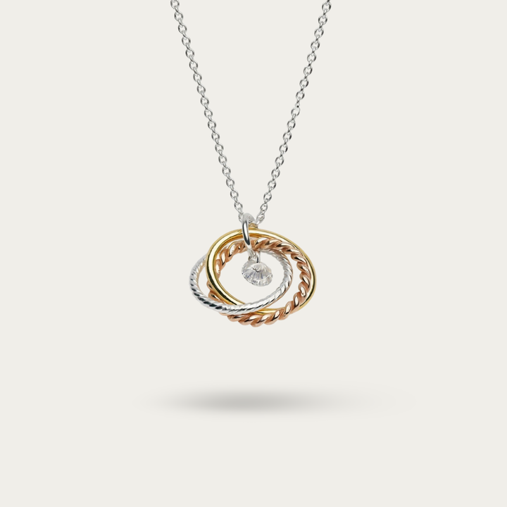 Necklace Intertwined 3 tone rings with a CZ drop