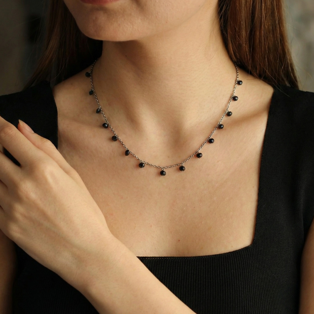 Necklace with drops of black crystals on dainty silver chain